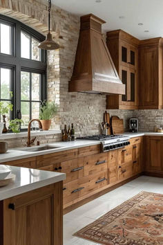 Rustic kitchen with wood cabinetry, exposed brick backsplash, farmhouse range hood, and natural textures for a warm and inviting atmosphere. Beautiful Wood Kitchen Cabinets, Tuscan Home Design, Rustic Interior Design Kitchen, Alder Kitchen Cabinets Farmhouse, Wood Stain Kitchen Cabinets, Modern Tuscan Home Interiors, Rustic Kitchen Cabinets Farmhouse Style, Kitchen Ideas Wood Cabinets, French Kitchen Ideas