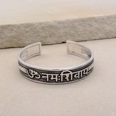 About item Item :-  Kriya Bangles Kada Ring size :- Chose from variation (Custom size accepted) Material  :- German Silver, Brass Title:-Om Namah Shivay Sacred Bracelets, Mantra Bracelet "Aum Namah Shivay "Open Face Cuff Bangle, Sacred Bracelets for Spiritual Bliss, Yoga Gifts, God Shiva bangles, Om Spiritual Jewelry, Valentine's day gift, Christmas day gift Description:- We accept all types of custom & personalized order. Please send us a message if you are interested in a custom creation. What Symbolic Festival Bangle Bracelet, Adjustable Silver Bracelets For Festivals, Symbolic Bangle Bracelets For Festivals, Adjustable Symbolic Bangle, Adjustable Symbolic Bangle Bracelet, Handmade Adjustable Spiritual Bangle, Adjustable Bracelets For Meditation And Festivals, Adjustable Spiritual Cuff Bracelet For Festivals, Adjustable Spiritual Bracelets For Festivals