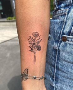 a woman's arm with a flower tattoo on the left side of her body