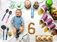 a baby laying on top of a table filled with food