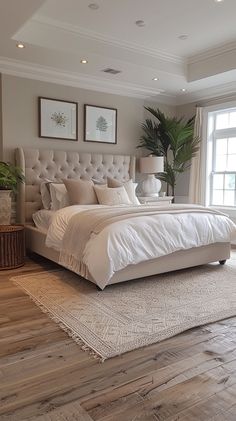 a large bed sitting in the middle of a bedroom next to a window with potted plants on it