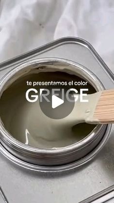 a paint can with a brush in it and the words grigge painted on top