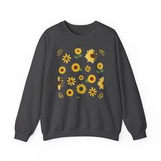 This vibrant Sunflower Burst Crewneck Sweatshirt boasts a cheery and bright design, perfect for adding a touch of summer fun to your wardrobe. Featuring a beautiful array of sunflowers and other spring florals, this pretty sweater is sure to make a statement. Stay stylish and comfortable all season long with its soft, long sleeve design. Ideal for any situation, a unisex heavy blend crewneck sweatshirt is pure comfort. These garments are made from polyester and cotton. This combination helps des Casual Printed Sweater For Spring, Fall Cotton Sweater With Floral Print, Fall Cotton Floral Print Sweater, Cotton Floral Print Fall Sweater, Cotton Floral Print Sweater For Fall, Yellow Long Sleeve Tops With Sunflower Print, Yellow Long Sleeve Top With Sunflower Print, Summer Crew Neck Sweater With Floral Print, Cotton Floral Print Sweatshirt For Fall