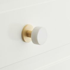 a close up of a knob on a white cabinet