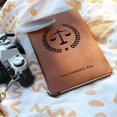 a camera and book on a bed