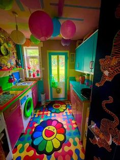 a brightly colored kitchen with colorful rugs on the floor and cabinets in the room