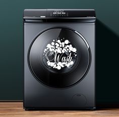 a black washer sitting on top of a wooden floor