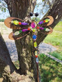 a wind catcher hanging from the side of a tree