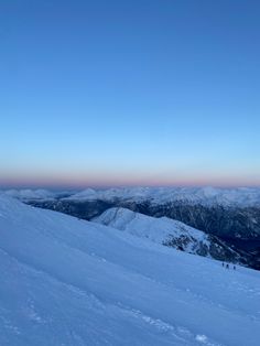 a person on skis is standing in the snow with mountains in the back ground