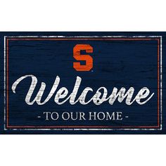 a wooden sign that says welcome to the team with an orange and blue s on it