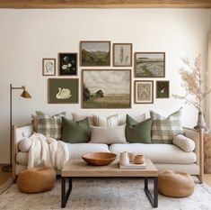 a living room filled with lots of furniture and pictures on the wall above it's coffee table