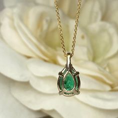 "The pendant pictured is a lab created green emerald #7033 -Approximate total carat weight: approx. 2.00ctw diamond equivalent -Center Stone Size: 10x7mm - approx. 2.00ct diamond equivalent -Center Stone Shape: pear -Gem Type: lab created Emerald -Stone Clarity: VS2 -Stone Color: Green -Moh's Scale: 9 hardness -Metal Type and Purity: 14k Yellow Gold -Setting: 5 prong -Chain: delicate 14k gold chain / heavier option with lobster claw available (use dropdown to select) -Country of Manufacturing: U Teardrop Emerald Gemstone Necklace For Formal Occasions, Emerald Pear-shaped Necklace For Anniversary, Yellow Gold Pear-shaped Necklace For May Birthstone, Pear-shaped Emerald Necklace In White Gold For Anniversary, Anniversary White Gold Pear-shaped Emerald Necklace, Classic Pear-shaped Emerald Necklace, Formal Emerald Teardrop Pendant Necklace, Formal Teardrop Emerald Necklace, Pear-shaped Emerald Necklace