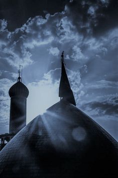 the sun shines brightly through the clouds over a building with two steeples on it