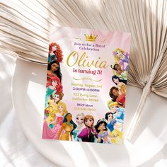 a princess birthday party is set up on a plate next to a palm frond