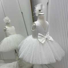 🌸 Ivory V-Back Dress, Elegant Wedding Dress, Christening Gown, Flower Girl Dress  🎀 A hair band is also sent as a gift along with this elegant dress. ✂️ Baby girl christening dress is handmade.  🌸The back of the dress consists of an open V back and a hidden zipper.  🌸The bow on the back can be removed.  🌸 The tutu tulle is fluffy to give a ballerina look.  🌸 The dress is extremely light and full.  ⭐️Our stunning knee-length flower girl dress is sure to turn heads. Your family and guests wi Elegant White Tutu Dress For Confirmation, Elegant White Tutu Dress For First Communion, White Princess Tutu Dress For Confirmation, Cream Sleeveless Princess Dress For Baptism, Cream Sleeveless First Communion Dress For Wedding, White Princess Tutu Dress For First Communion, Elegant Sleeveless Tutu Dress For First Communion, Elegant Sleeveless Tutu Dress For Baptism, Cream Princess Style Sleeveless Baptism Dress