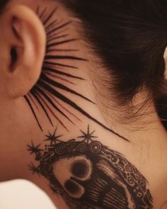 a woman's neck with a tattoo on it