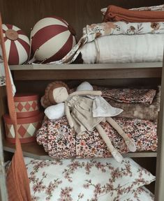 a shelf filled with lots of different types of cloths and toys on top of it