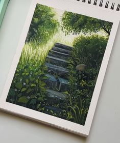 an open notebook with a drawing of steps in the grass