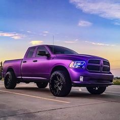 a purple truck parked in a parking lot