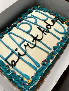 a birthday cake with blue frosting in a box