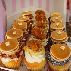 a plate topped with lots of different types of cakes and muffins on top of each other