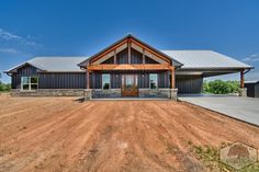 a large house sitting on top of a dirt field