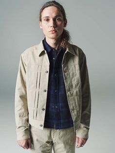 Cowboy jacket in burberry cloth. this simple work-style jacket has only a left breast pocket on the front and is tucked on both sides. both sides of the pockets and sleeve openings are accented with rivets made by end custom jewellers. the back of the jacket is accented with the letters' unique western patterned sleeves.    made from cotton. the material is a high-density woven cotton gabardine so-called "burberry cloth." after weaving the fabric is washer-finished and tumbled-dried to bring out Rugged Utility Jacket With Double-needle Stitching, Unstructured Button-up Utility Jacket, Varsity-style Cotton Outerwear With Button Closure, Rugged Cotton Button-up Outerwear, Cowboy Jacket, Luxury Single-breasted Men's Utility Jacket, Easy Tiger, Black Tank Dress, Black Aviators