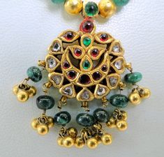 "Vintage antique solid 22 K gold Kundan work pendant necklace. Uncut diamond set with rubies and emeralds in very classic style strung with natural Emerald and gold beads. Total Length of necklace-46 cm(18 \") we can adjust length. size of only pendant-4/2.5 cm, total weight-25 grams(0.87 ounces), Net gold weight approx-15 grams(0.52 ounces)." Antique Gold Necklace With Multi-stones, Traditional 22k Gold Multi-stone Necklaces, Antique Gold Multi-stone Necklace, Traditional Multi-stone 22k Gold Necklace, Traditional Gold Emerald Gemstone Necklace, Traditional Round Kundan Necklace With Jewels, Gold Round Emerald Necklace In Temple Jewelry Style, Gold Temple Jewelry Style Emerald Necklace, Traditional Yellow Gold Multi-stone Necklace