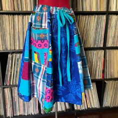 there is a skirt on display in front of the record shelf with records behind it