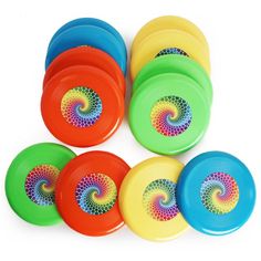 six frisbees with different colors and designs on the top one has a spiral design