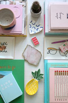 various office supplies laid out on top of each other, including notebooks and pens