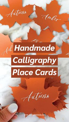 handmade calligraphy place cards with the words autumn written in red and white on them