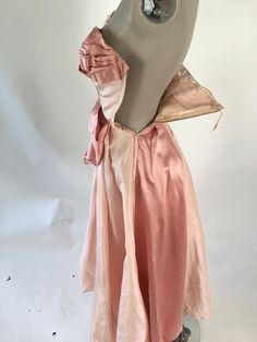 "1950's couture silk ball gown with a satin stripe and enormous bow. Metal side zipper. Discoloration and some shattering under arms is covered by lace. Several very small holes in the skirt, do not affect the integrity of the dress Size XS Bust: 32\" Waist: 23\" Hips: free Skirt Length: 42\"" Vintage Ball Gown Dress For Party, Vintage Party Dress With Bow, Vintage Evening Dress With Boned Bodice, Vintage Ball Gown With Boned Bodice For Events, Vintage Events Boned Bodice Ball Gown, Vintage Evening Ball Gown Dress, Vintage Prom Dress With Boned Bodice, Ball Gown With Boned Bodice For Vintage Events, Vintage Satin Dress With Boned Bodice