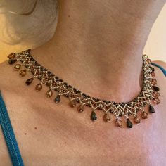 "I call this collar style 'Egyptian Lace,' which seems to sum up the differing elements that make this such a beautifully delicate necklace.  Gold, bronze, and brown seed and drop beads for a Fall aesthetic.  Clasp is gold-plated. Length is approximately 17.25\" including clasp. If you are seeking something specific, let me know - custom orders are a delight! I want you to be happy with your order, so I do accept returns provided the item is unused and in it's original condition.  Please let me know within three days of receipt.  Return postage will be the buyer's responsibility." Gold Drop Bohemian Necklace, Bohemian Gold Drop Necklace, Brown Beaded Teardrop Jewelry, Bohemian Gold Teardrop Pendant Drop Necklace, Gold Bohemian Teardrop Pendant Drop Necklace, Bohemian Gold Teardrop Pendant Necklace, Elegant Brown Necklace With Dangling Beads, Elegant Brown Beaded Crystal Necklaces, Bohemian Amber Teardrop Necklace