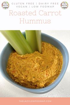 roasted carrot hummus in a blue bowl with celery on top and text overlay that reads gluen free dairy - free, vegan low fodmap