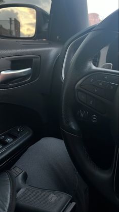 the interior of a car with steering wheel and dash board