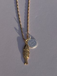 Embrace the symbolism of luck and resilience with our wish fish piece - featuring a mini coy fish charm and sterling silver gold luck disc. The piece embodies the spirit of perseverance and good fortune associated with coy fish. Whether as a personal talisman or a thoughtful gift, this piece serves as a reminder to navigate life's currents with grace and determination. Fish Necklaces Jewelry, Tiny Fish Necklace, Fish Locket In Gold, Gold Fish-shaped Necklace For Gift, Coy Fish, Fish Necklace, Good Fortune, The Spirit, Thoughtful Gifts