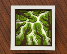 an image of trees cut out of paper on a wooden background with text overlay