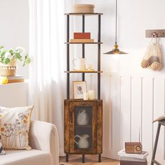 a living room filled with furniture next to a wall mounted shelf full of pictures and candles