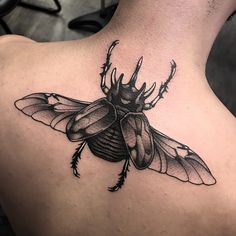 a black and white photo of a bug on the back of a man's neck