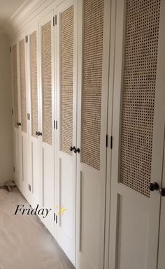 an empty room with white cupboards and carpeted flooring in the middle of it