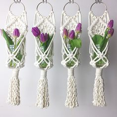 four vases with purple tulips tied together