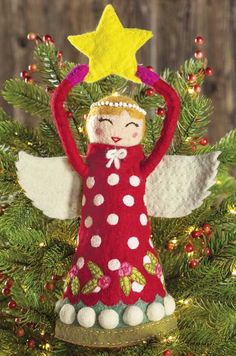 a christmas tree ornament with an angel holding a star