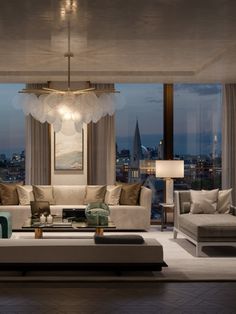 a living room filled with furniture and a large window overlooking the city at night time