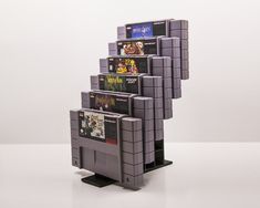 a stack of video games sitting on top of a white table next to each other