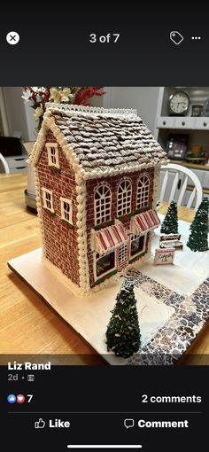 a gingerbread house on a table with christmas decorations