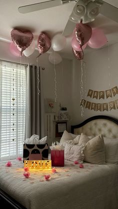 a bedroom decorated with pink and white balloons