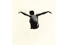 a man diving into the water with his arms outstretched