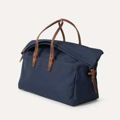 Cabine Travel bag - Navy Blue | Bleu de chauffe Functional Blue Shoulder Bag For Travel, Blue Rectangular Bag With Luggage Sleeve, Casual Satchel Bag With Luggage Sleeve, Blue Satchel Shoulder Bag With Luggage Sleeve, Blue Rectangular Satchel With Luggage Sleeve, Double Handle Bags With Adjustable Strap For Overnight Trips, Casual Canvas Bag For Overnight Trips, Blue Travel Satchel With Luggage Sleeve, Blue Satchel With Luggage Sleeve For Travel