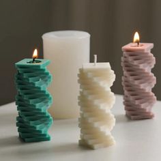 three candles sitting next to each other on a table